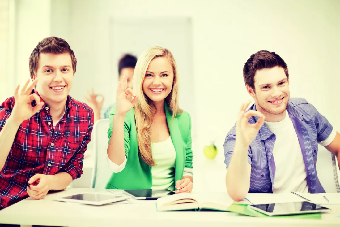education-technology-smiling-students-with-tablet-pcs-showing-ok-sign-school