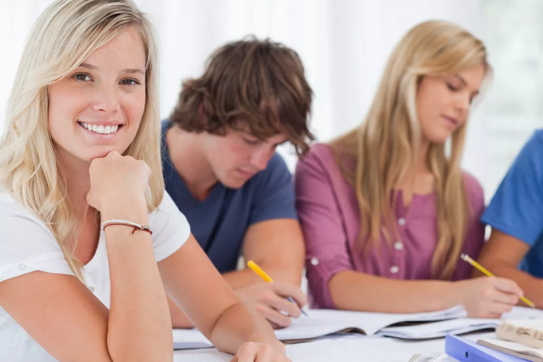close-up-smiling-girl-with-her-friends-as-she-looks-camera