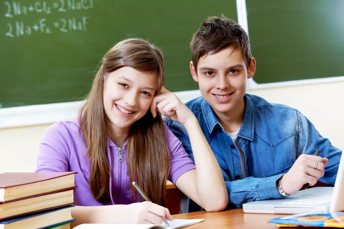 students-working-together-with-blackboard-background