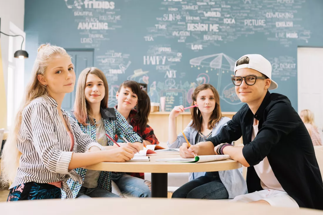 group-students-posing-table