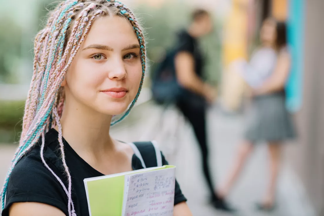 dreamy-teen-schoolgirl-with-textbook