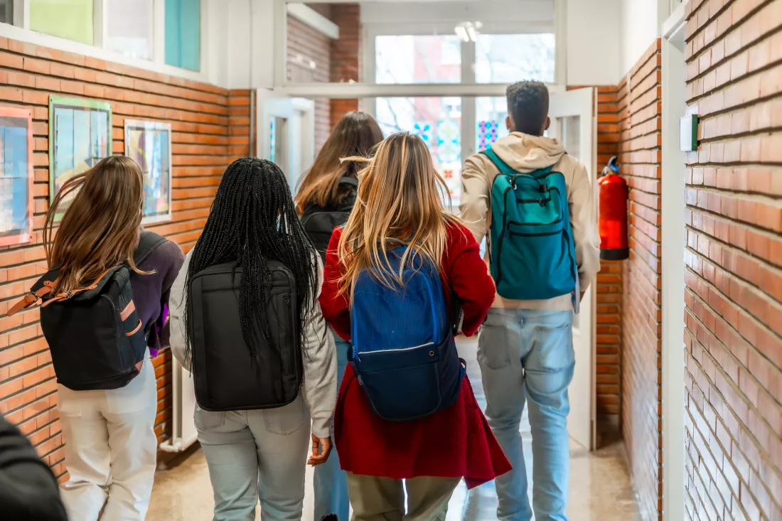 students-walking-down-school-hallway-after-class