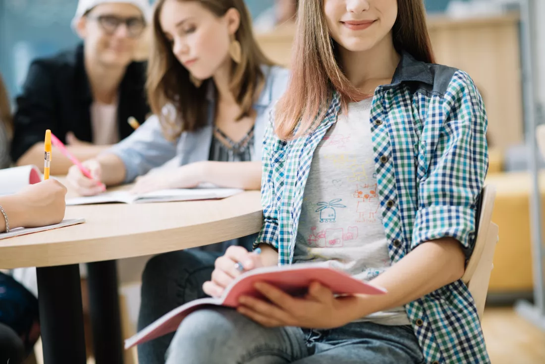 crop-schoolgirl-sitting-with-studies-chair
