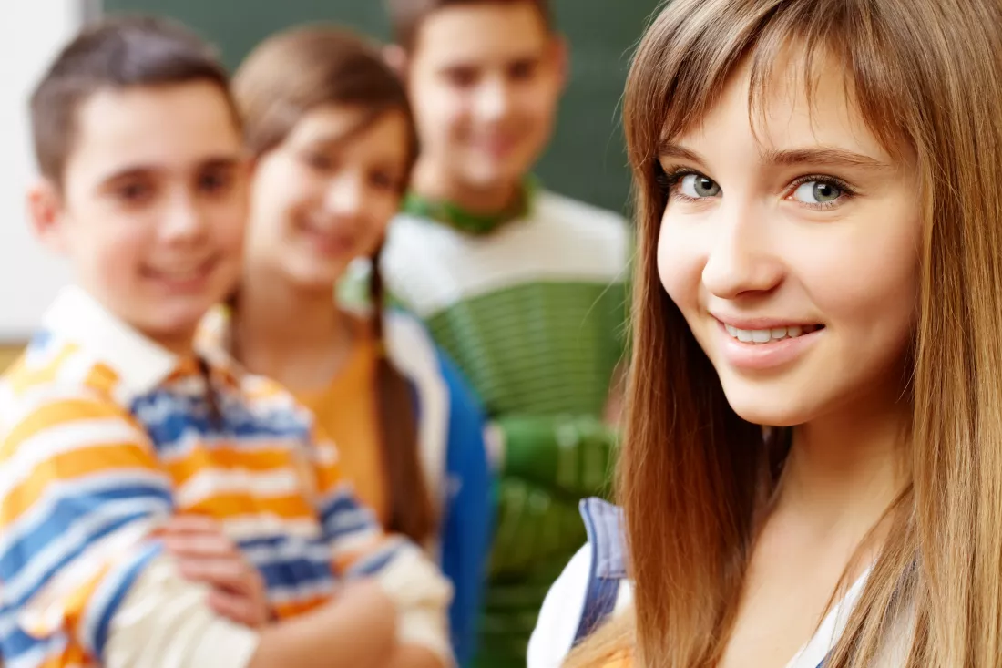 smiling-student-with-classmates-blurred-background