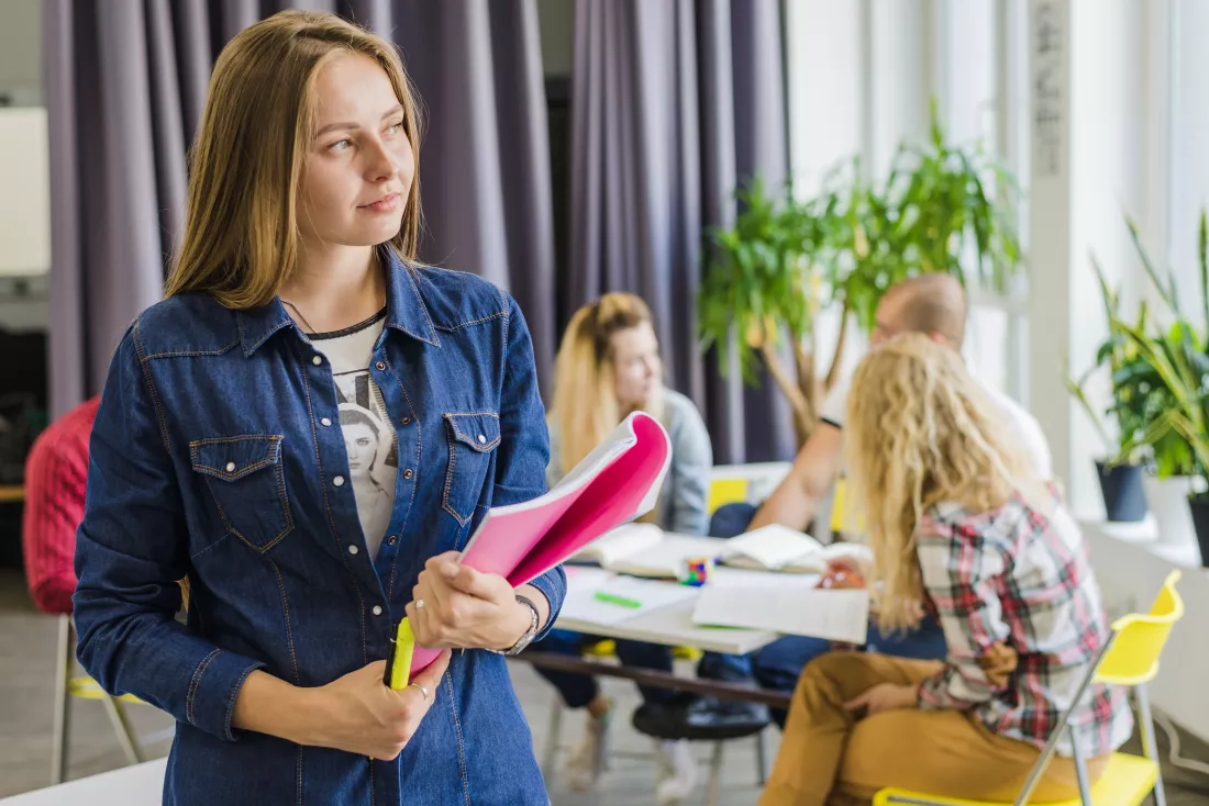 young-dreaming-woman-posing-with-textbook